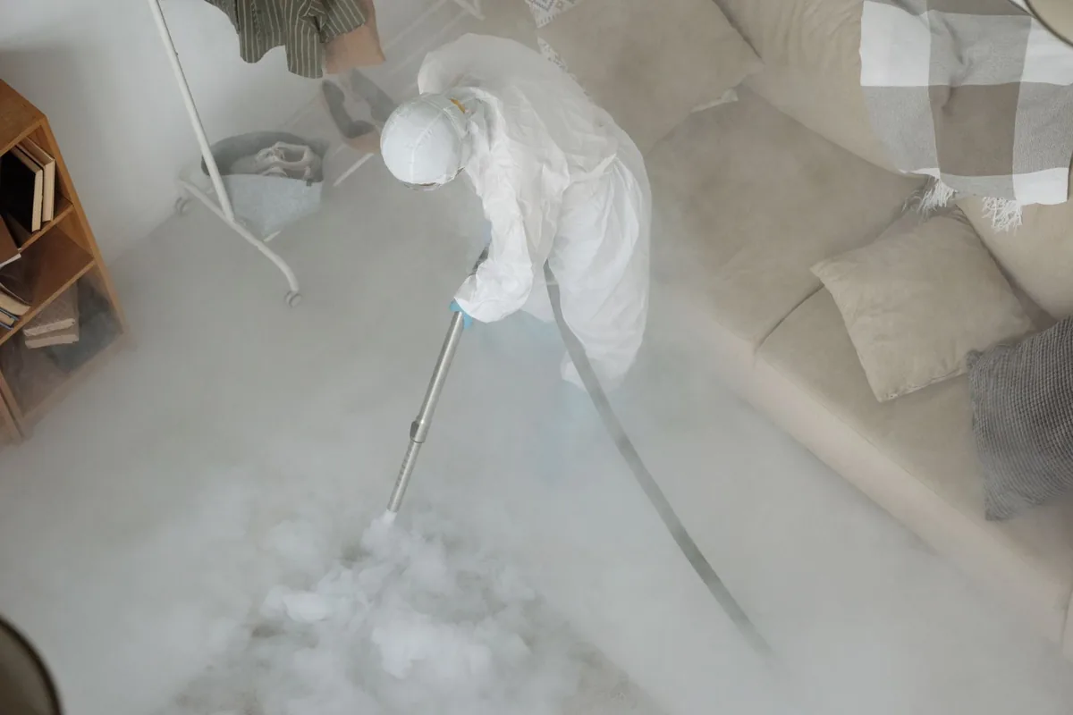 Biohazard cleanup technician in protective equipment, Kensington Park, FL